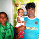 Janardhan Koli with his wife and daughter at their one-room home in Madh Koliwada.